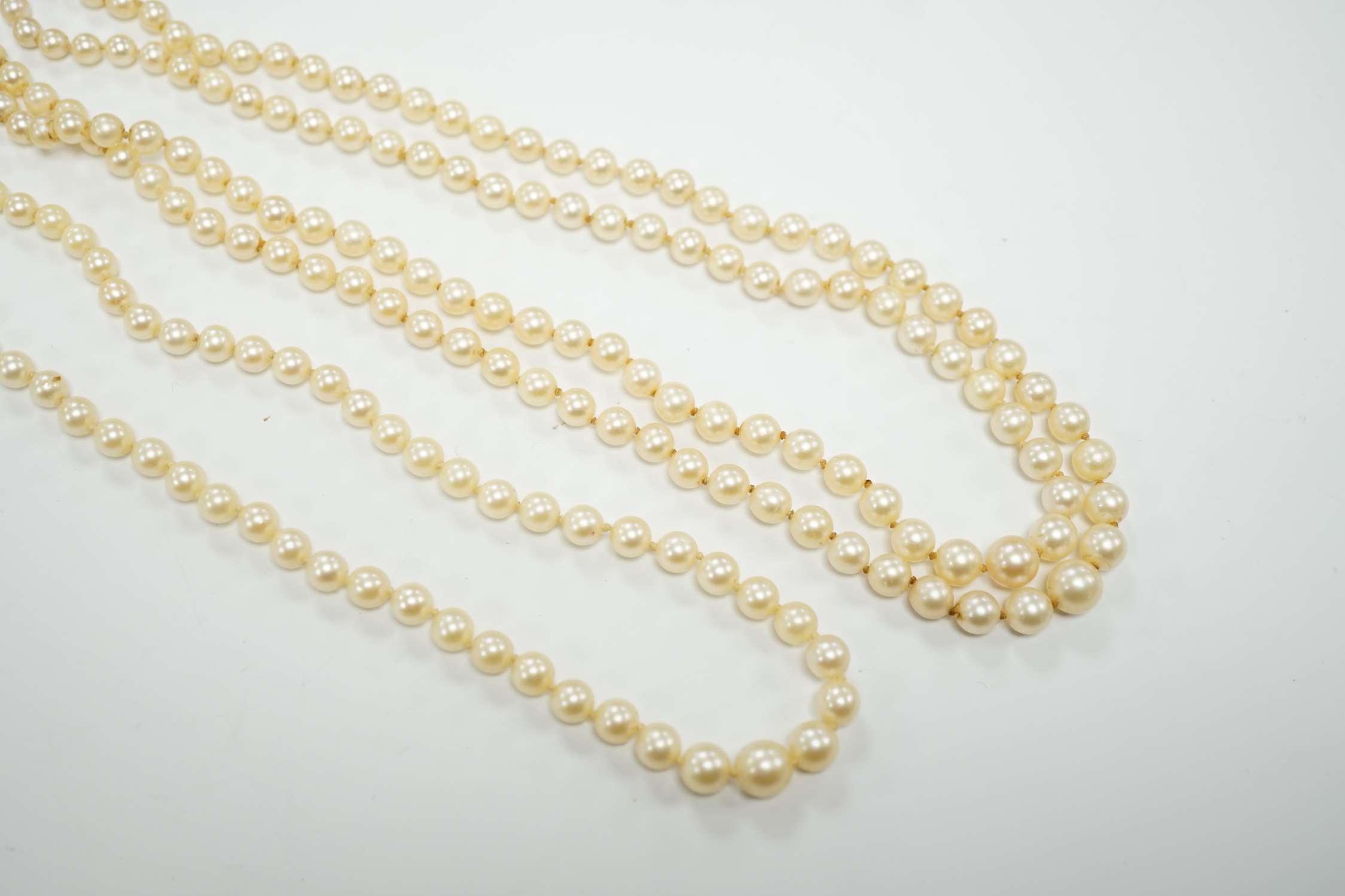 A double strand graduated cultured pearl necklace, with a white metal clasp, 48cm, together with a similar single strand graduated cultured pearl necklace